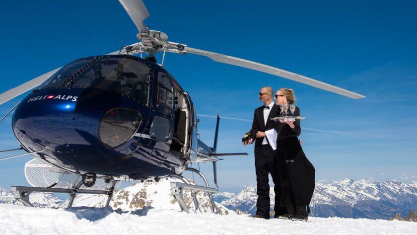 helicopter and young couple at the mountain top