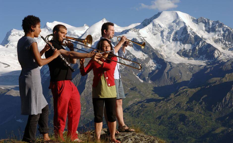 Young people playing trumpets in Verbier mountain